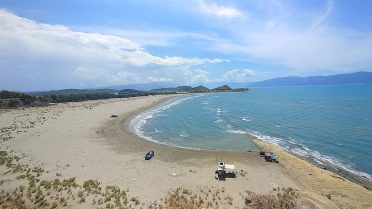Dzikia plaża nad zatoką podczas wyprawy motocyklowej Albania – Macedonia, turkusowa woda i bałkańskie krajobrazy.
